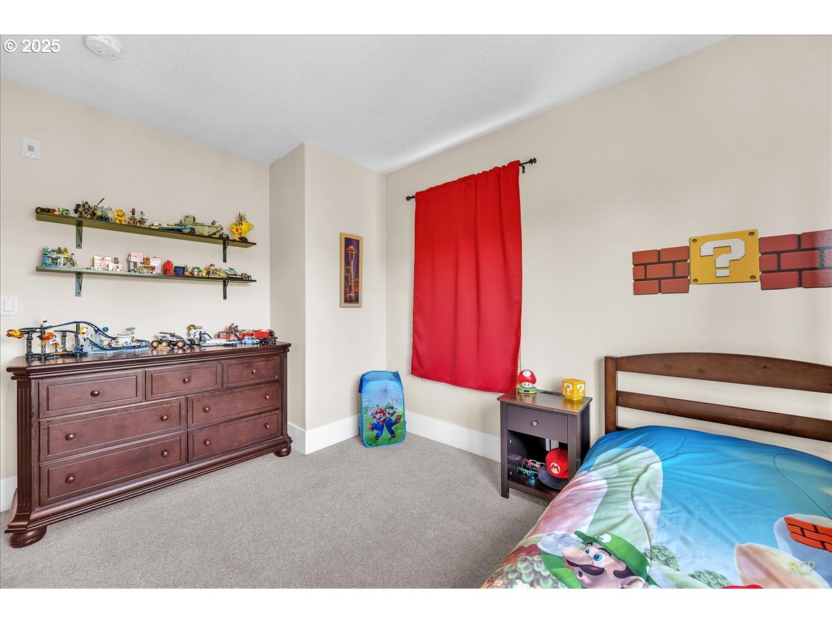 794 Northwest 118th Avenue, Unit 101 Portland, OR 97229 - Photo 29 of 41 a bed room with a bed and a window
