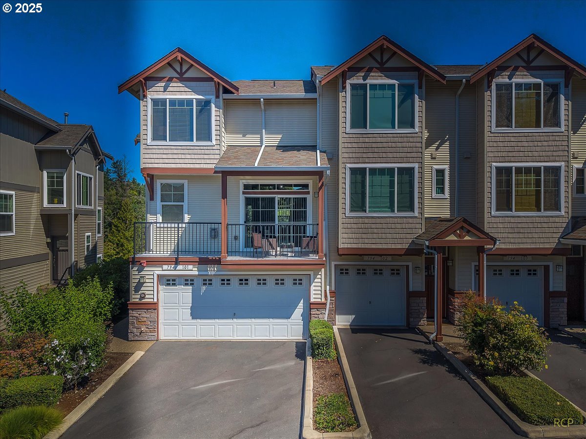 794 Northwest 118th Avenue, Unit 101 Portland, OR 97229 - Photo 3 of 41 a front view of a house with a yard and garage