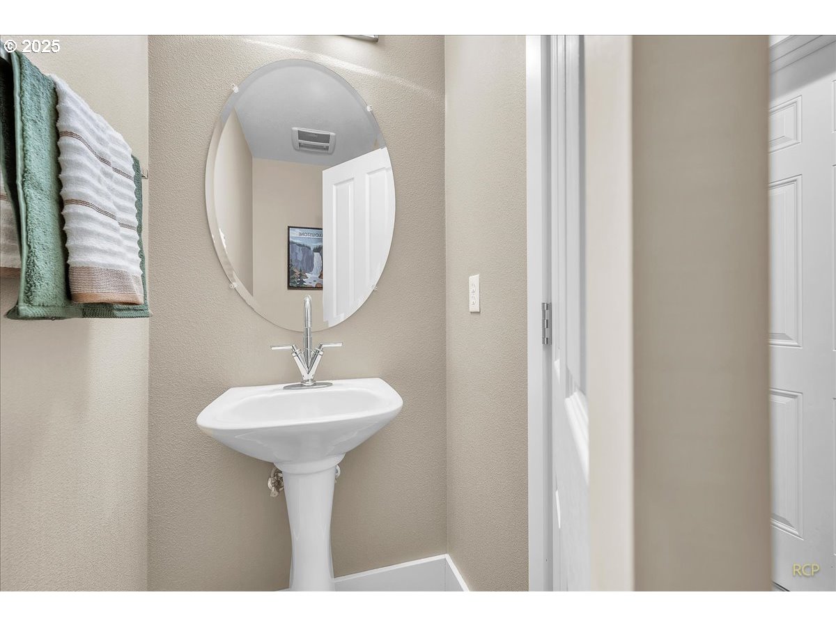 794 Northwest 118th Avenue, Unit 101 Portland, OR 97229 - Photo 6 of 41 a bathroom with a sink and a mirror