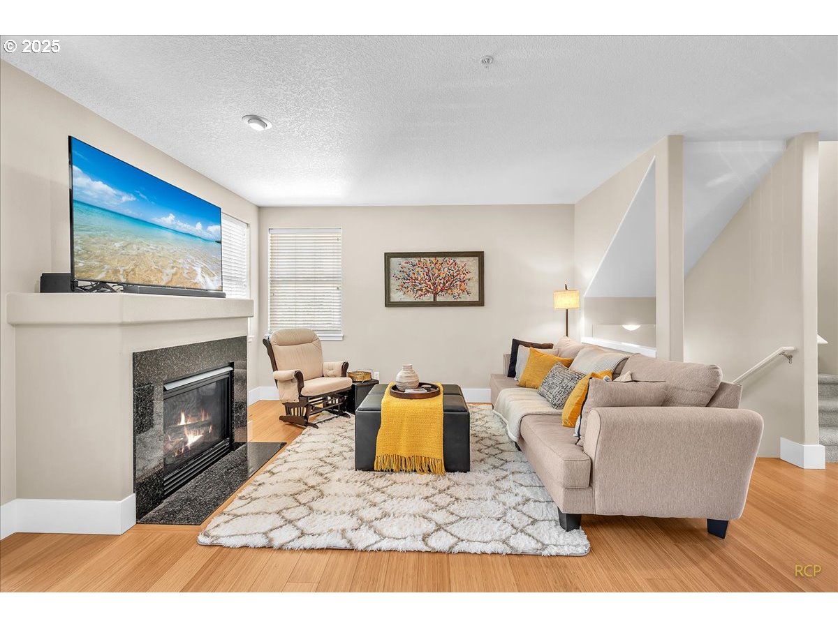794 Northwest 118th Avenue, Unit 101 Portland, OR 97229 - Photo 7 of 41 a living room with furniture and a fireplace