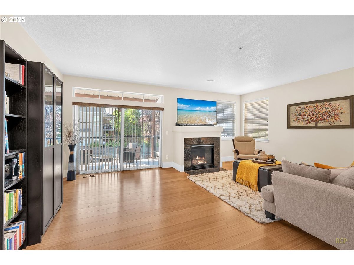 794 Northwest 118th Avenue, Unit 101 Portland, OR 97229 - Photo 8 of 41 a living room with furniture and a fireplace