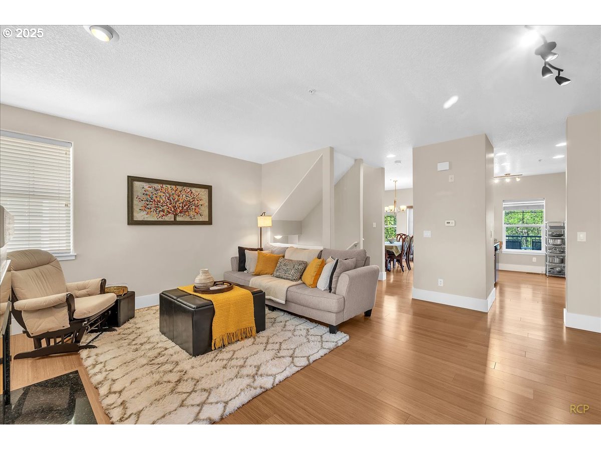 794 Northwest 118th Avenue, Unit 101 Portland, OR 97229 - Photo 10 of 41 a living room with furniture and a wooden floor