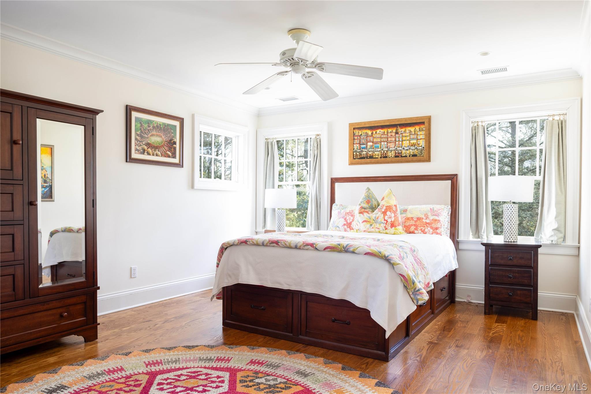 53 Cedar Lane West Remsenburg, NY 11960 - Photo 25 of 38 Bedroom with visible vents, ornamental molding, and wood finished floors