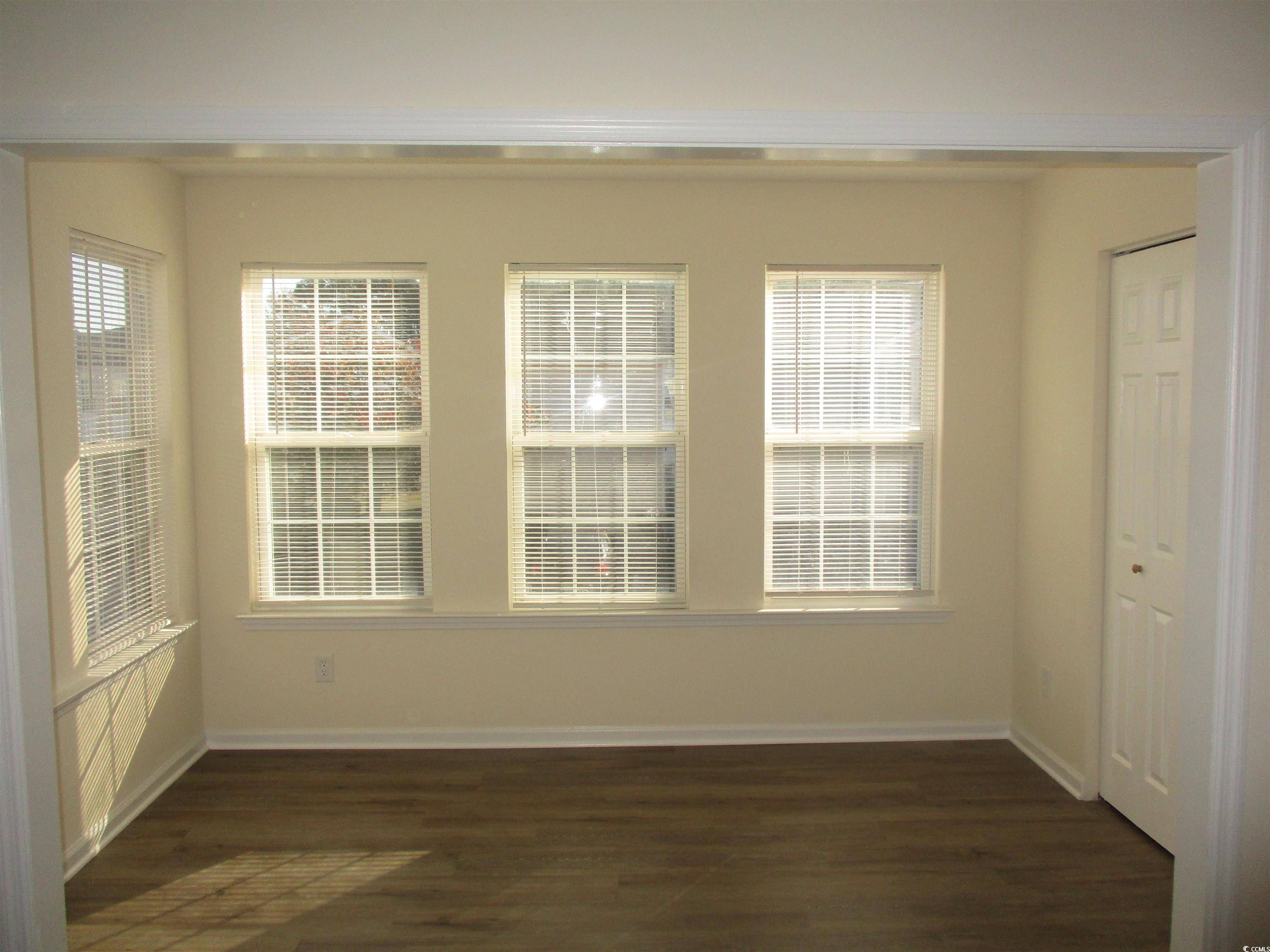 8545 Hopkins Circle Surfside Beach, SC 29575 - Photo 9 of 24 Empty room with dark wood-type flooring