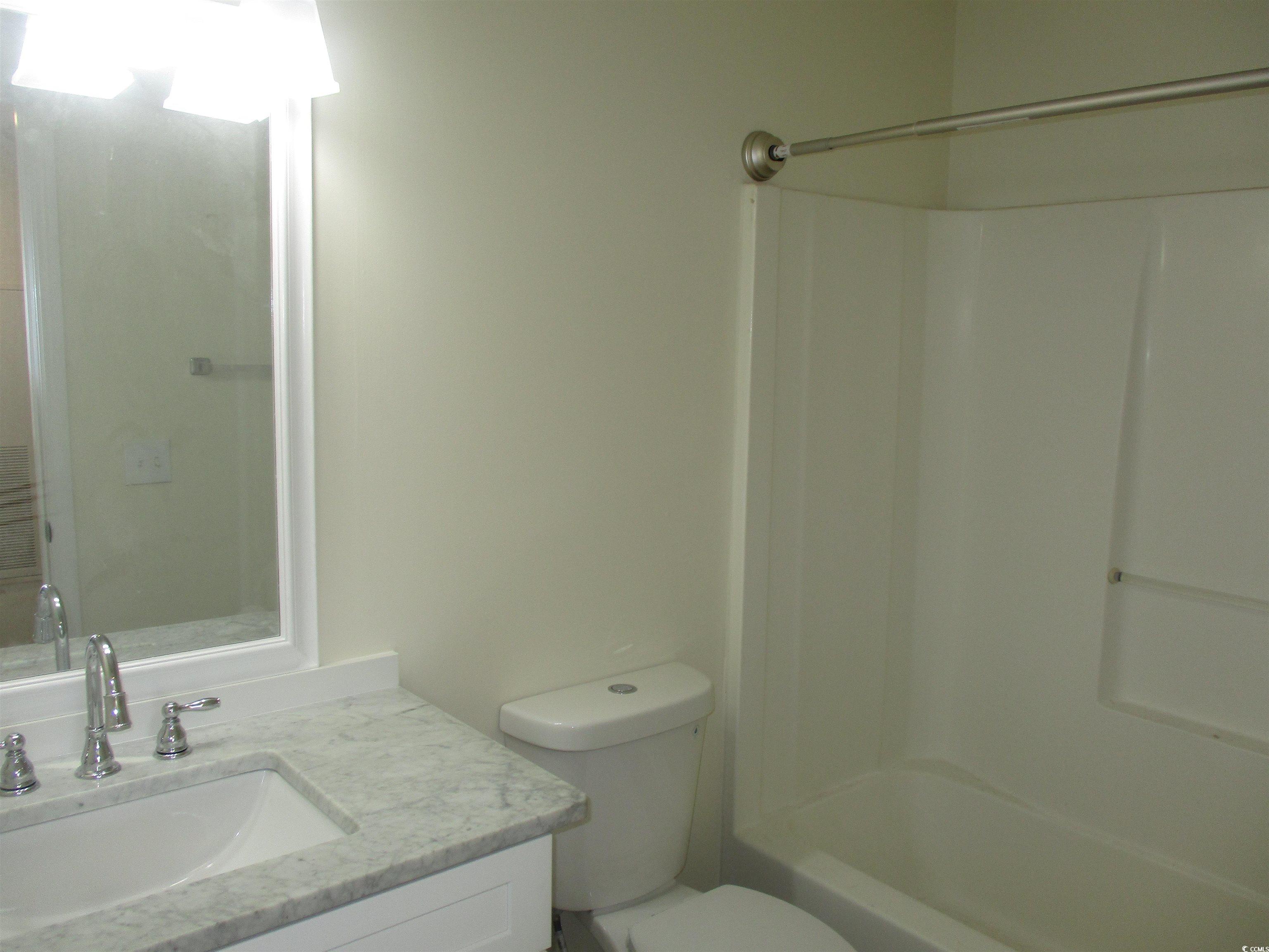 8545 Hopkins Circle Surfside Beach, SC 29575 - Photo 15 of 24 Bathroom featuring vanity and shower / tub combination