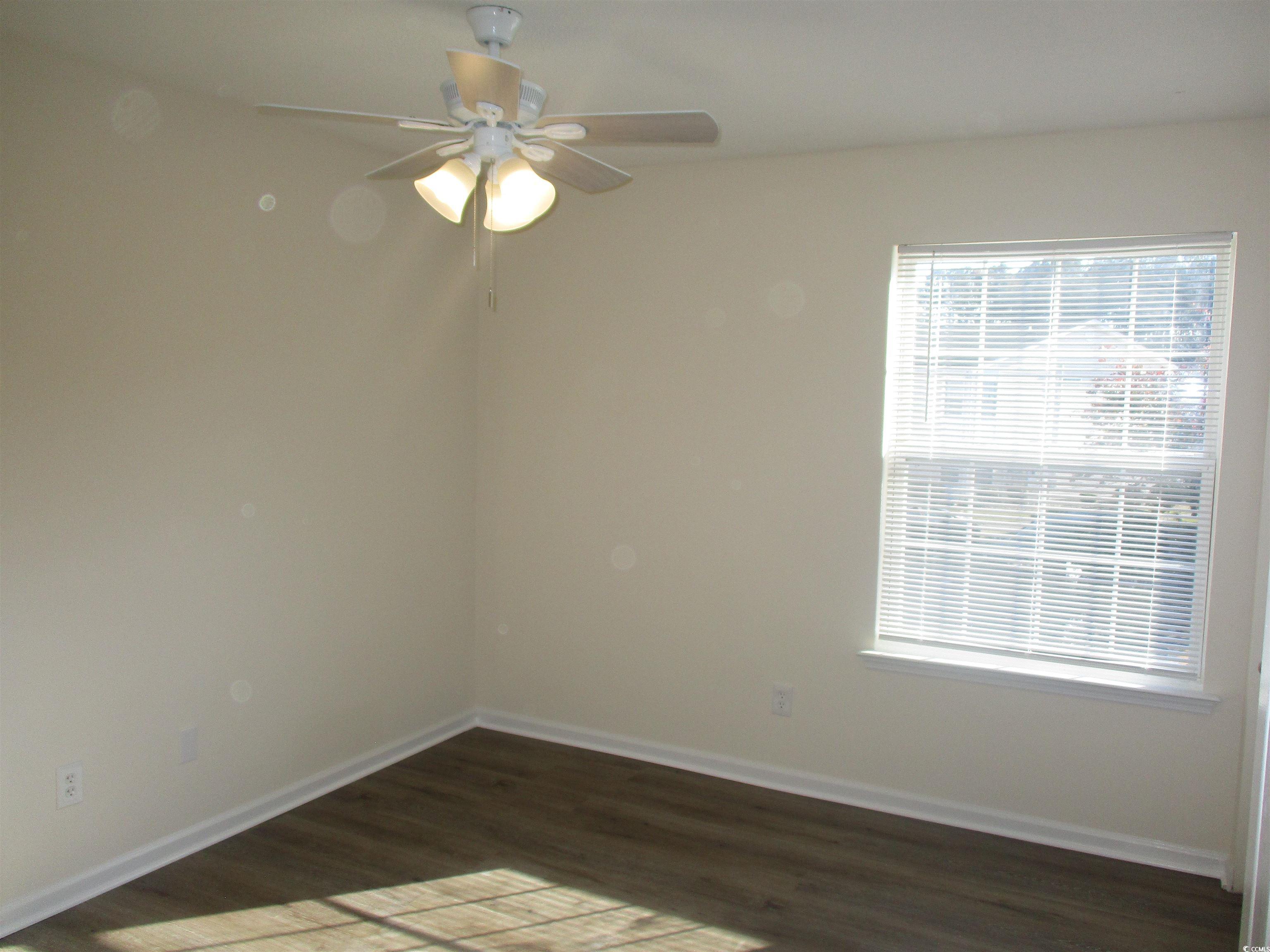 8545 Hopkins Circle Surfside Beach, SC 29575 - Photo 16 of 24 Empty room featuring dark wood-style floors and ceiling fan