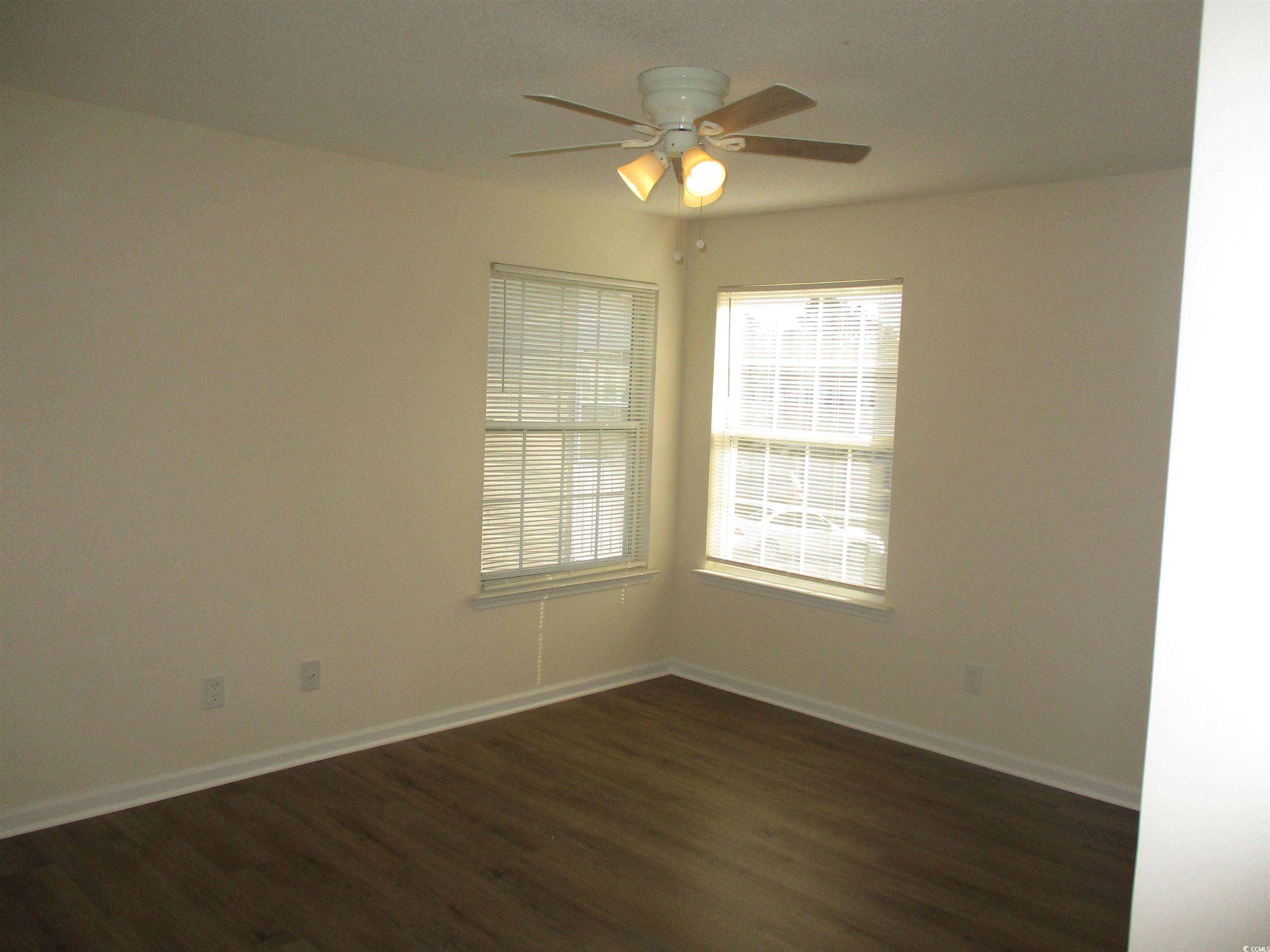 8545 Hopkins Circle Surfside Beach, SC 29575 - Photo 19 of 24 Empty room featuring dark wood-style floors and a ceiling fan