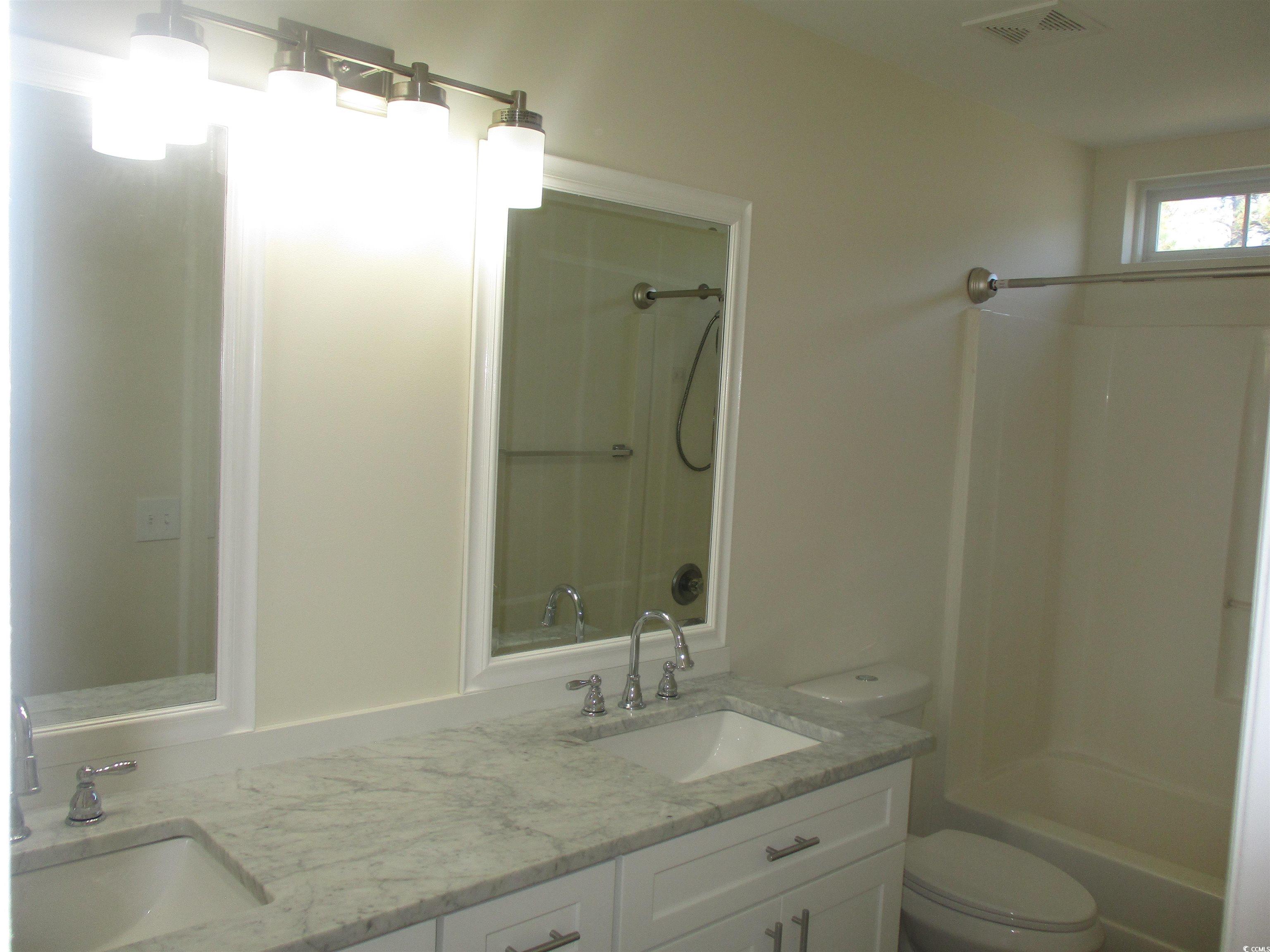 8545 Hopkins Circle Surfside Beach, SC 29575 - Photo 21 of 24 Bathroom featuring double vanity and shower combination