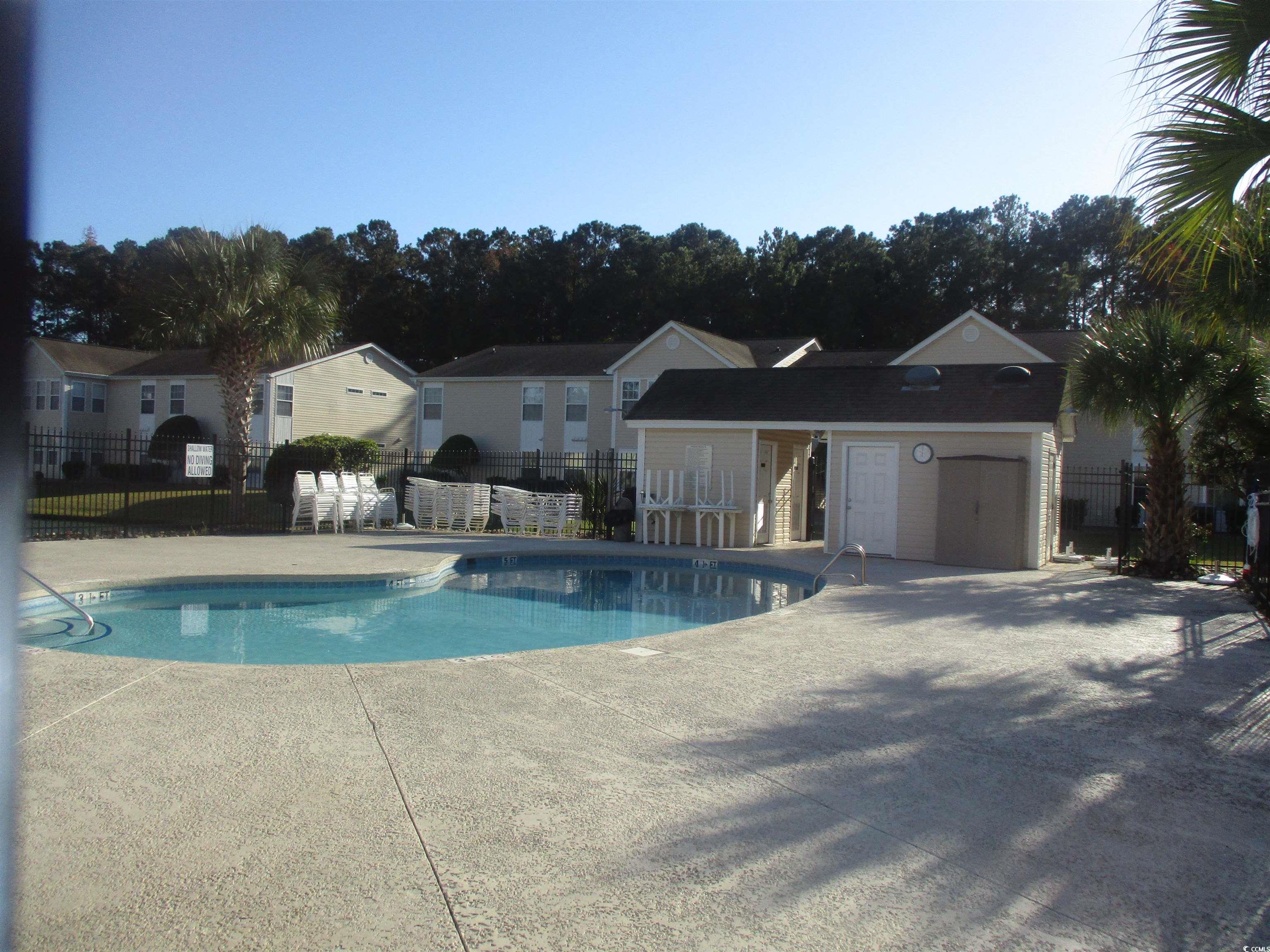 8545 Hopkins Circle Surfside Beach, SC 29575 - Photo 3 of 24 Community pool featuring a patio area