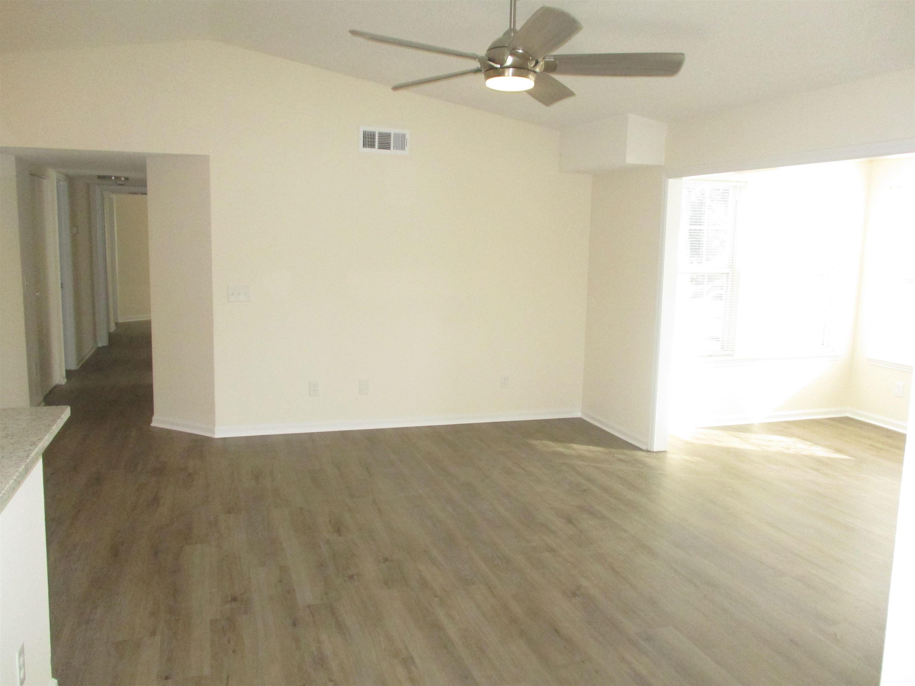 8545 Hopkins Circle Surfside Beach, SC 29575 - Photo 7 of 24 Spare room featuring wood finished floors, lofted ceiling, and a ceiling fan