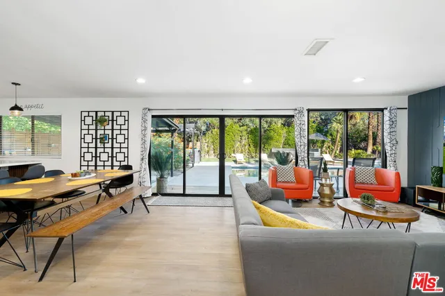 a living room with furniture and kitchen view