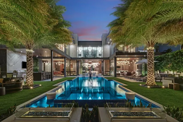 a view of a house with swimming pool and sitting area