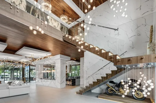 a living room with a large window and furniture