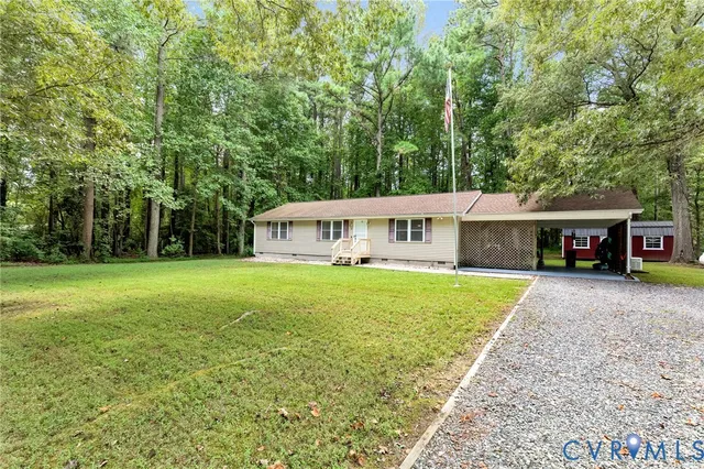 a front view of a house with a yard and trees