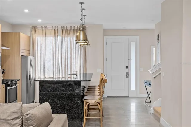 a living room with furniture a fireplace and a chandelier