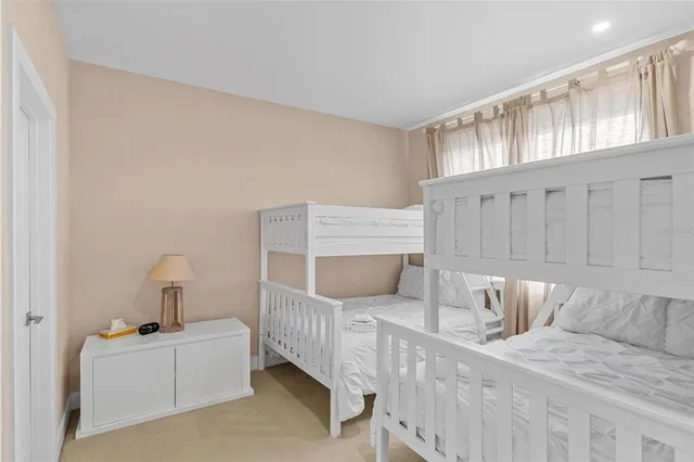 a bedroom with furniture and baby crib