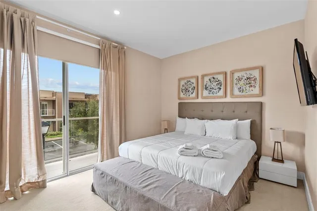 a bedroom with a large bed and a large window