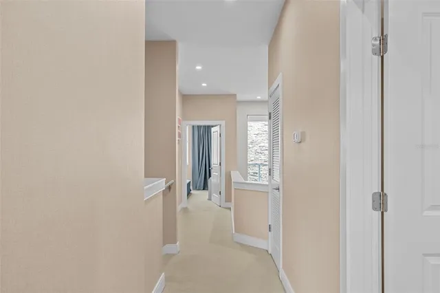a view of a hallway with wooden floor and entryway