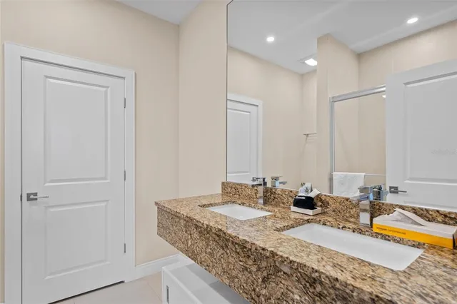 a bathroom with sinks granite vanity and a mirror