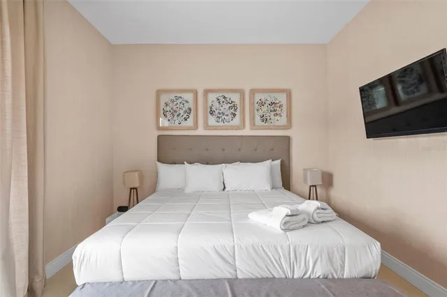 a bedroom with a bed and a tv