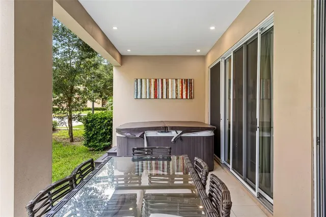 a view of a patio with a table chairs and a yard