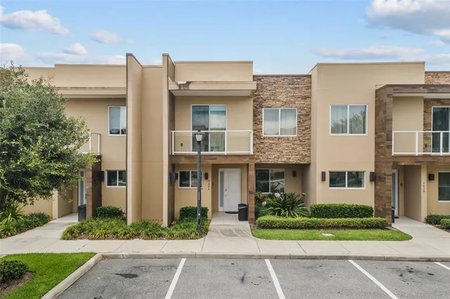 an aerial view of multi story residential apartment building with a yard