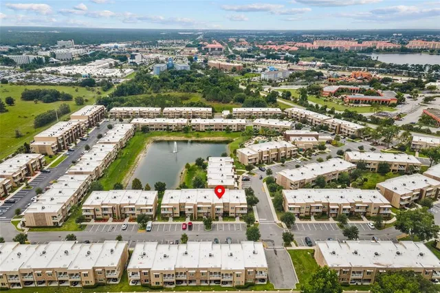 an aerial view of a house with a garden and lake view