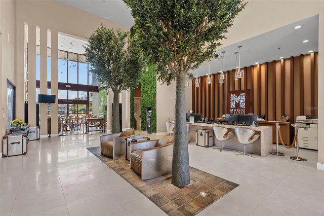 a living room with furniture and a potted plant
