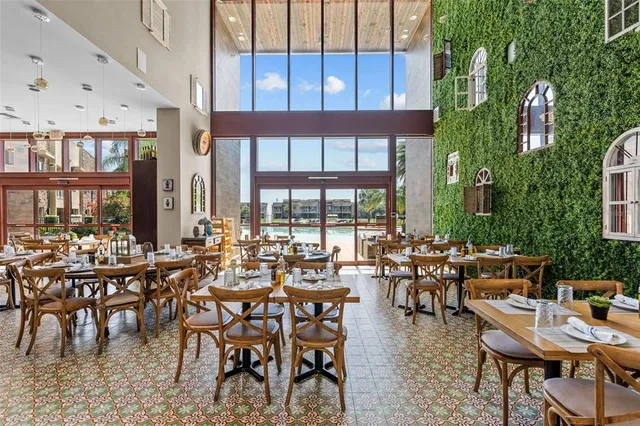 a view of a swimming pool with a garden and lawn chairs