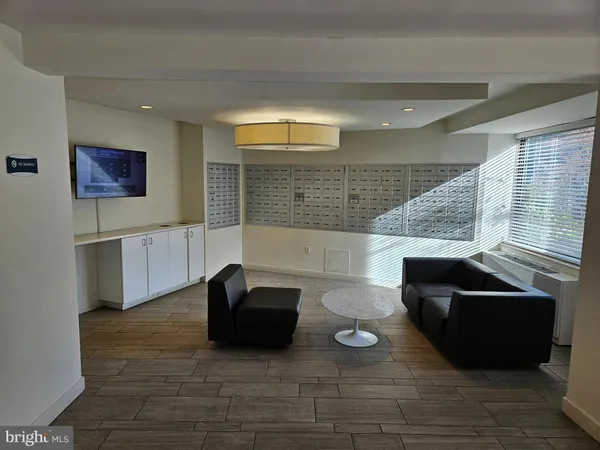 a living room with couches and a flat screen tv