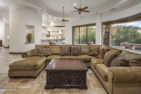 a view of a hallway to a room with a dining space and a fireplace