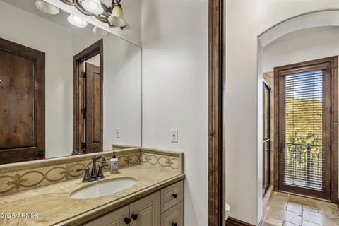 a bathroom with a granite countertop sink a toilet and shower