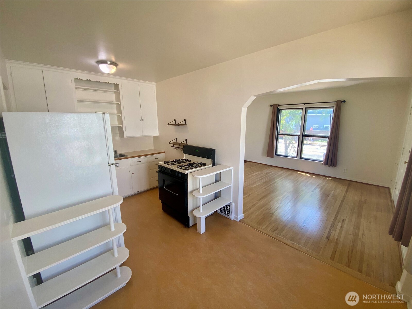 5708 8th Avenue Northwest Seattle, WA 98107 - Photo 6 of 15 a kitchen with stainless steel appliances a refrigerator and a stove top oven