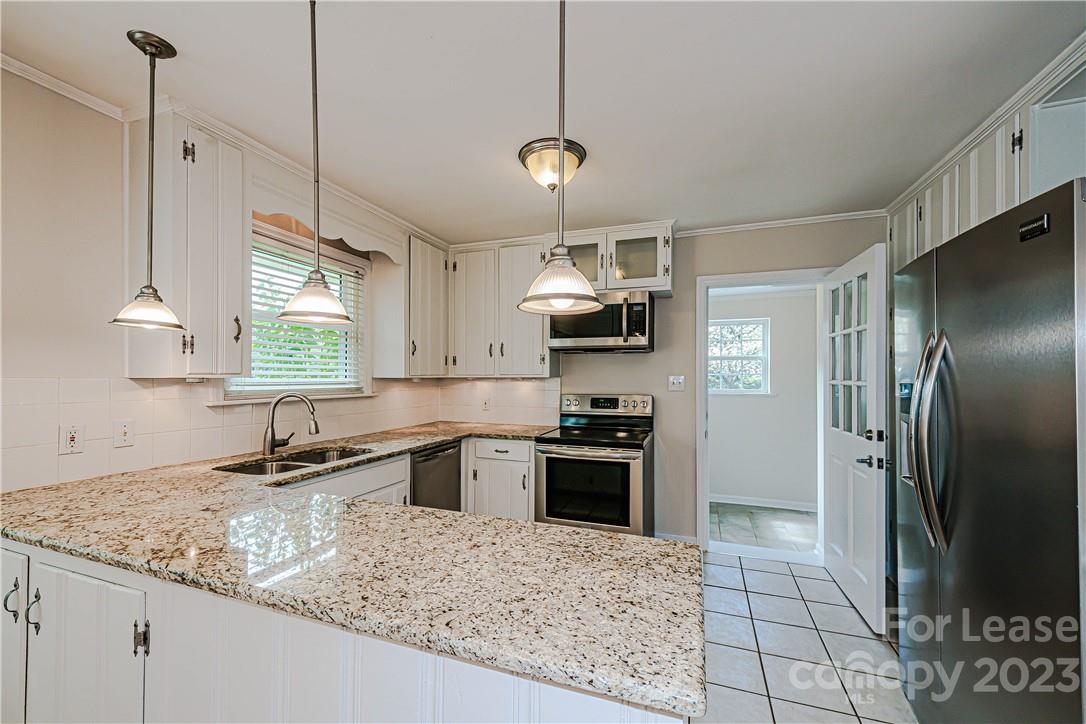 4301 Applegate Road Charlotte, NC 28209 - Photo 7 of 21 a kitchen with stainless steel appliances granite countertop a sink refrigerator and microwave