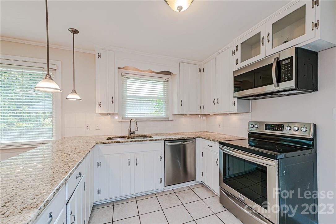 4301 Applegate Road Charlotte, NC 28209 - Photo 8 of 21 a kitchen with stainless steel appliances granite countertop a sink stove and microwave