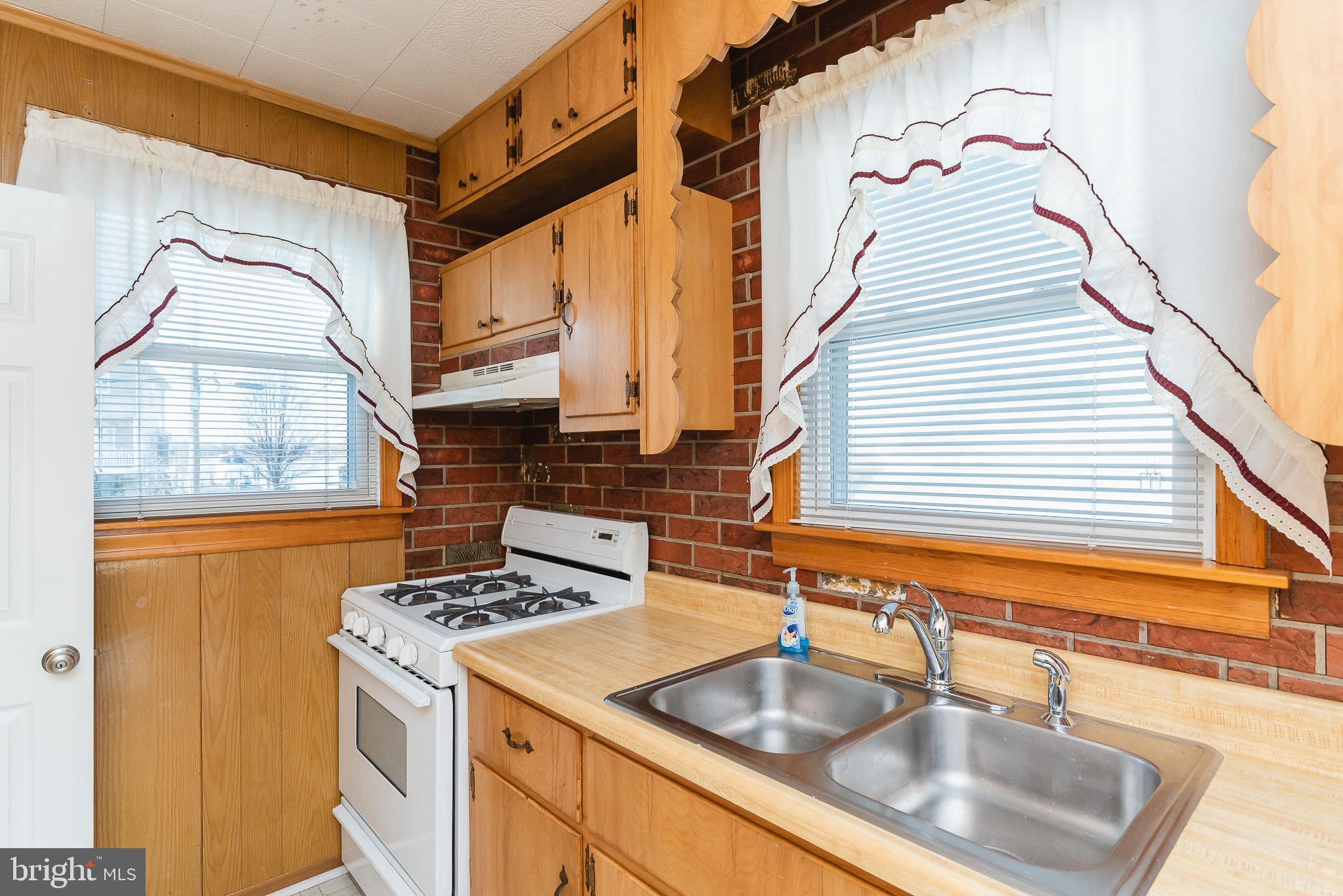 3230 Lynch Road Baltimore, MD 21219 - Photo 22 of 43 a kitchen with a sink cabinets and a large window