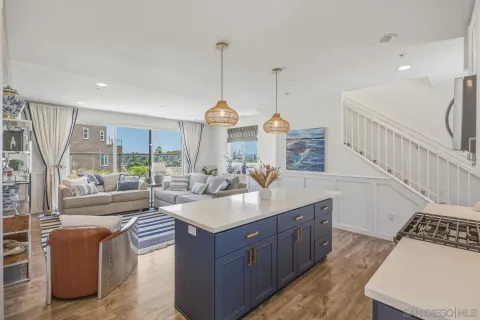 a kitchen with stainless steel appliances granite countertop a sink a stove and a refrigerator
