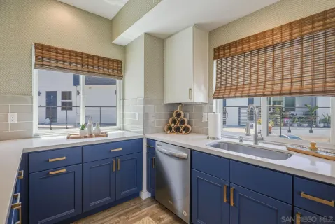 a large kitchen with stainless steel appliances granite countertop a stove a refrigerator a oven a large island with wooden cabinets and floor