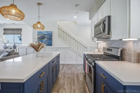 a large kitchen with a table chairs wooden floor and a fireplace