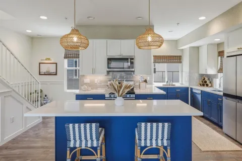 a kitchen with stainless steel appliances granite countertop a stove a kitchen island a dining table and chairs with wooden floor