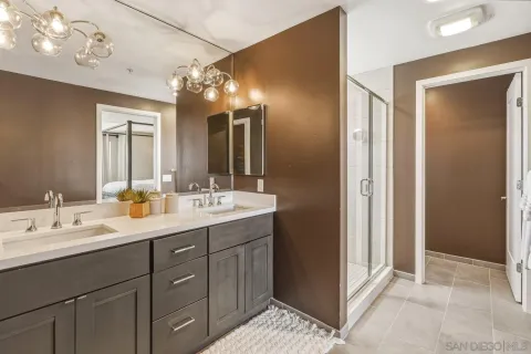 a bathroom with a double vanity sink and a mirror