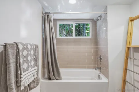 a bathroom with a sink a large mirror and shower