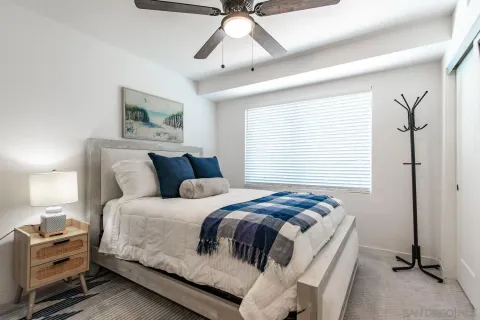 a bedroom with a large bed and a window