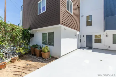 a view of a brick building next to a yard