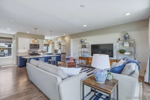 a living room with furniture kitchen view and a table