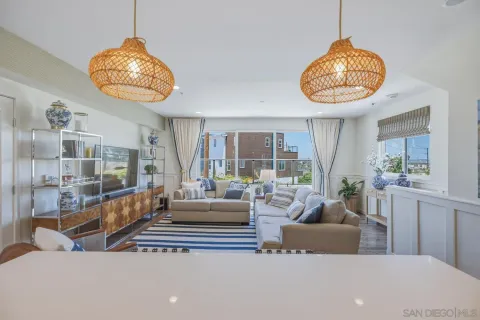 a kitchen with stainless steel appliances granite countertop a stove a sink dishwasher a dining table and chairs with wooden floor