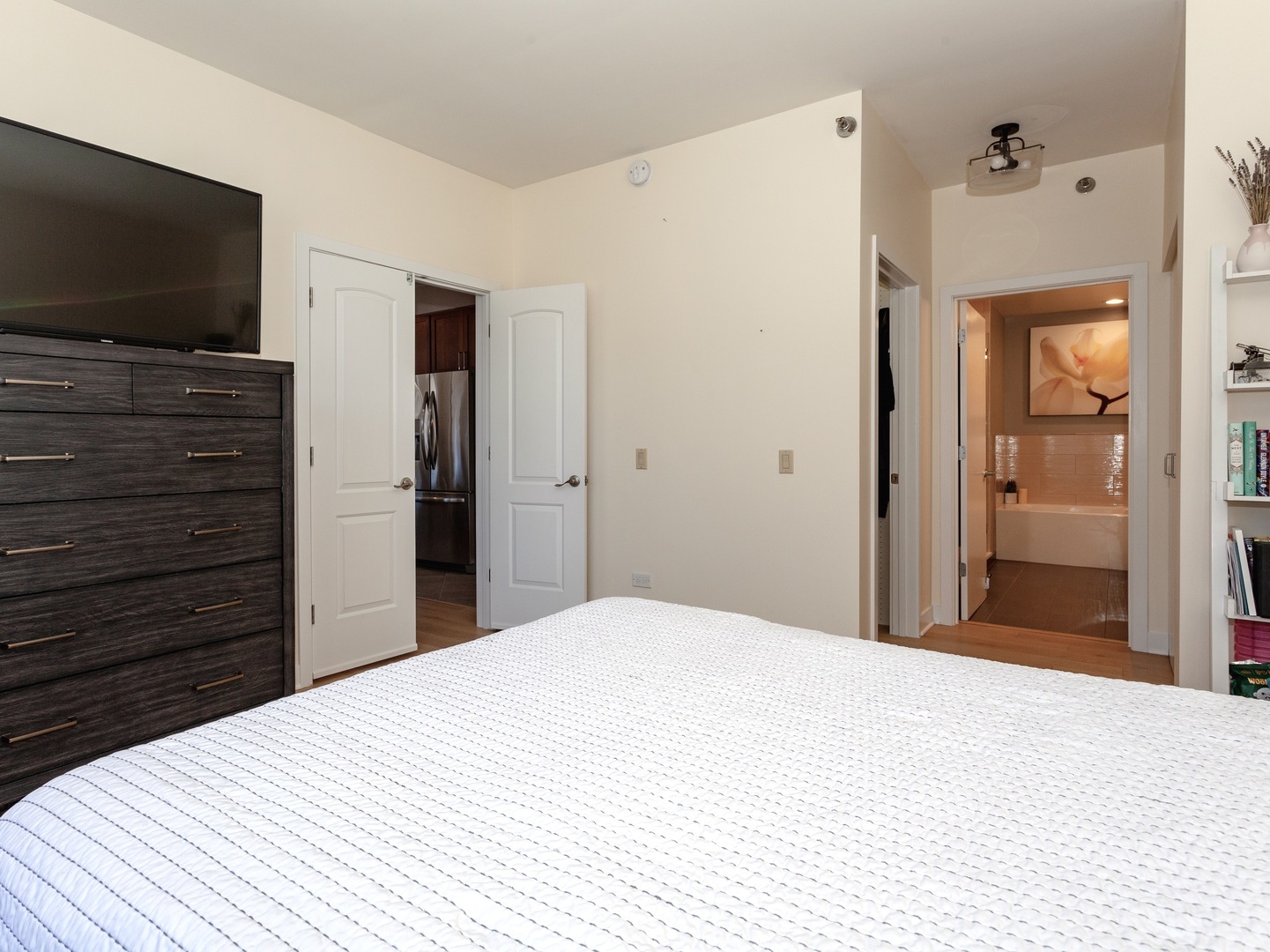 330 North Jefferson Street, Unit 904 Chicago, IL 60661 - Photo 11 of 22 a bedroom with a bed and a flat screen tv