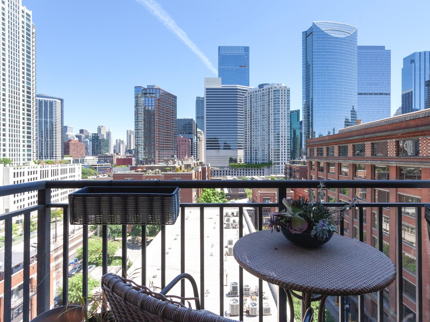 330 North Jefferson Street, Unit 904 Chicago, IL 60661 - Photo 16 of 22 a view of a balcony with a table and chairs