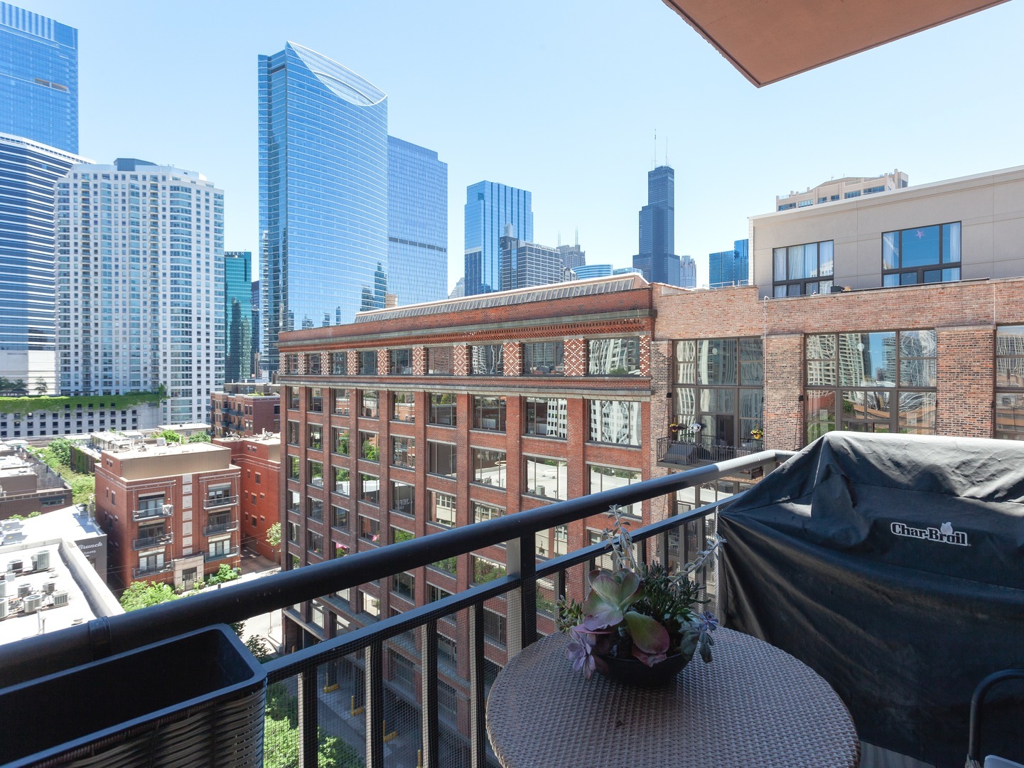 330 North Jefferson Street, Unit 904 Chicago, IL 60661 - Photo 17 of 22 a view of a balcony with two chairs and a table