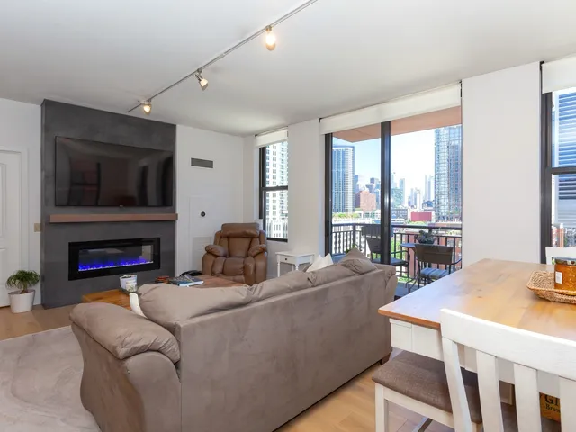 a living room with fireplace furniture and a flat screen tv